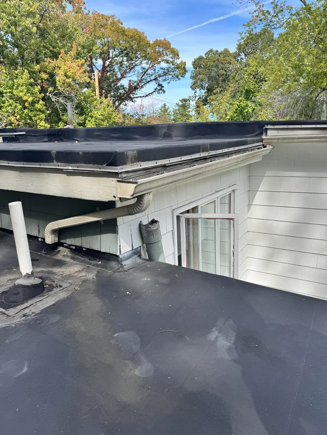 why does this gutter drain onto another flat roof instead v0 uz5g0dgusxqf1